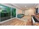 Basement living room featuring comfortable couch, sliding glass door and hardwood floors at 617 Pinecrest St, Davidson, NC 28036