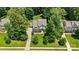 A picturesque aerial view of a beautifully landscaped home with a long driveway at 6422 Northern Red Oak Dr, Mint Hill, NC 28227
