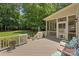 Spacious back deck with screened in porch and view of the lush green backyard at 6422 Northern Red Oak Dr, Mint Hill, NC 28227