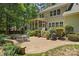 Enjoy this charming brick patio with a dining set, grill, and lush garden at 6422 Northern Red Oak Dr, Mint Hill, NC 28227