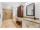 Spacious bathroom featuring double sinks with granite countertops, a large mirror, and a walk-in shower at 6422 Northern Red Oak Dr, Mint Hill, NC 28227