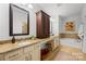Well-lit bathroom featuring double sinks with granite countertops, a tub and an abundance of storage at 6422 Northern Red Oak Dr, Mint Hill, NC 28227