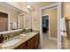Bathroom with double sinks, granite countertop, and convenient access to the closet at 6422 Northern Red Oak Dr, Mint Hill, NC 28227