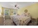 Bright bedroom with two windows, ceiling fan, and comfortable beds at 6422 Northern Red Oak Dr, Mint Hill, NC 28227