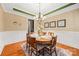 A formal dining room with a chandelier and an elegant round table set for dinner at 6422 Northern Red Oak Dr, Mint Hill, NC 28227