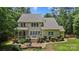 Charming home showcasing outdoor living with a patio and deck, surrounded by lush landscaping at 6422 Northern Red Oak Dr, Mint Hill, NC 28227