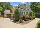 Side view of a home with lush landscaping and a two-car garage at 6422 Northern Red Oak Dr, Mint Hill, NC 28227