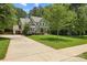 View of the two-car garage and manicured lawn with sidewalk leading to the front door at 6422 Northern Red Oak Dr, Mint Hill, NC 28227