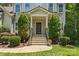 The home has a covered front entrance with stone steps and manicured bushes at 6422 Northern Red Oak Dr, Mint Hill, NC 28227