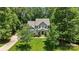 An elevated view of the traditional home surrounded by mature trees and landscaping at 6422 Northern Red Oak Dr, Mint Hill, NC 28227