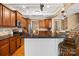 Updated kitchen featuring stainless appliances, an island with breakfast bar, and rich wood cabinetry at 6422 Northern Red Oak Dr, Mint Hill, NC 28227