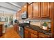 Well-appointed kitchen with stainless steel appliances, dark countertops, and hardwood floors at 6422 Northern Red Oak Dr, Mint Hill, NC 28227