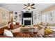 Inviting living room with built-in shelving, a cozy fireplace, and comfortable seating arrangements at 6422 Northern Red Oak Dr, Mint Hill, NC 28227