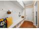 Charming mudroom with built-in bench, storage cubbies, beadboard wainscoting and hardwood floors at 6422 Northern Red Oak Dr, Mint Hill, NC 28227