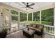 Cozy screened porch featuring comfortable seating, an outdoor ceiling fan and views of the backyard at 6422 Northern Red Oak Dr, Mint Hill, NC 28227