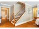 Elegant staircase with hardwood steps, detailed iron railings, and natural light at 6422 Northern Red Oak Dr, Mint Hill, NC 28227