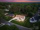 Picture of an elevated home with a well-manicured lawn and backyard pool in a peaceful neighborhood at 6505 Folger Dr, Charlotte, NC 28270