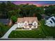 Aerial view of a well-manicured lawn and a two-story white brick home at 6505 Folger Dr, Charlotte, NC 28270