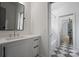 Contemporary bathroom featuring a large mirror, modern vanity, and a black-and-white tiled floor at 6505 Folger Dr, Charlotte, NC 28270