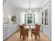 Dining room features natural light, hardwood floors, elegant chandelier, and seating for four at 6505 Folger Dr, Charlotte, NC 28270