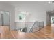 Bright hallway with hardwood floors, staircase, and a chandelier, creating an elegant and inviting space at 6505 Folger Dr, Charlotte, NC 28270