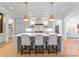 Modern kitchen with a large island, pendant lighting, and stainless steel appliances at 6505 Folger Dr, Charlotte, NC 28270