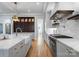 Well-lit kitchen with hardwood floors, stainless steel appliances, marble countertops, and custom cabinetry at 6505 Folger Dr, Charlotte, NC 28270