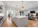 Open-concept kitchen with a large island, flowing into the dining and living areas at 6505 Folger Dr, Charlotte, NC 28270