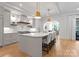 Bright kitchen features a large island, hardwood floors, modern lighting and stainless steel appliances at 6505 Folger Dr, Charlotte, NC 28270