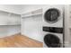 This laundry room features a stacked washer and dryer and shelving at 6505 Folger Dr, Charlotte, NC 28270
