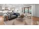 Living room features an open layout, hardwood floors, modern furniture, and natural light at 6505 Folger Dr, Charlotte, NC 28270