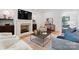 Living room features a fireplace, hardwood floors, modern furniture, and an open layout at 6505 Folger Dr, Charlotte, NC 28270