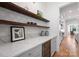This pantry features wood shelves, a wine fridge, and white countertops at 6505 Folger Dr, Charlotte, NC 28270