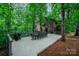 Expansive back deck with outdoor dining set, perfect for entertaining amidst lush greenery at 676 Cottingham Ne Pl, Concord, NC 28025