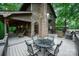 Spacious outdoor deck with dining and seating areas, ideal for enjoying the surrounding nature at 676 Cottingham Ne Pl, Concord, NC 28025