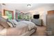 Comfortable bedroom with neutral tones, a large window, and stylish furnishings at 676 Cottingham Ne Pl, Concord, NC 28025