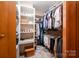 Walk-in closet with shelving, hanging racks, and neutral carpet at 676 Cottingham Ne Pl, Concord, NC 28025