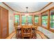 Inviting dining area with hardwood floors, wood trim, and large windows offering scenic views at 676 Cottingham Ne Pl, Concord, NC 28025