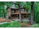 Charming home exterior with a covered porch, bench, and lush landscaping at 676 Cottingham Ne Pl, Concord, NC 28025