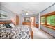 Main bedroom features gray walls, white carpet, a ceiling fan, an en suite bathroom and view of the back yard at 676 Cottingham Ne Pl, Concord, NC 28025