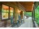 Charming porch adorned with rocking chairs and rustic wood finishes, offering a relaxing outdoor space at 676 Cottingham Ne Pl, Concord, NC 28025