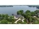 Stunning aerial view of lakefront home, boasting a private dock, pool and meticulously landscaped grounds at 8170 Bay Pointe Dr, Denver, NC 28037