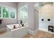 Modern bathroom with a large soaking tub and tiled walk-in shower at 8170 Bay Pointe Dr, Denver, NC 28037