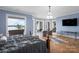 Bright primary bedroom with water views, stylish chandelier, and hardwood flooring at 8170 Bay Pointe Dr, Denver, NC 28037