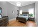 Bedroom with wood floors, dresser, and bed with bedside tables at 8170 Bay Pointe Dr, Denver, NC 28037