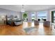 Expansive primary bedroom features hardwood floors, decorative chandelier, and a view of the lake at 8170 Bay Pointe Dr, Denver, NC 28037