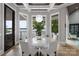 Lake views from this dining room with a large marble table and modern lighting at 8170 Bay Pointe Dr, Denver, NC 28037