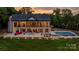 Expansive home exterior featuring a multi-level patio, swimming pool, and lush green lawn, great for entertaining at 8170 Bay Pointe Dr, Denver, NC 28037