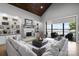 Spacious living room with built-in shelving, a fireplace, and access to an outdoor seating area at 8170 Bay Pointe Dr, Denver, NC 28037