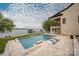 Backyard features a luxurious in-ground pool, expansive patio, and lake views at 8170 Bay Pointe Dr, Denver, NC 28037